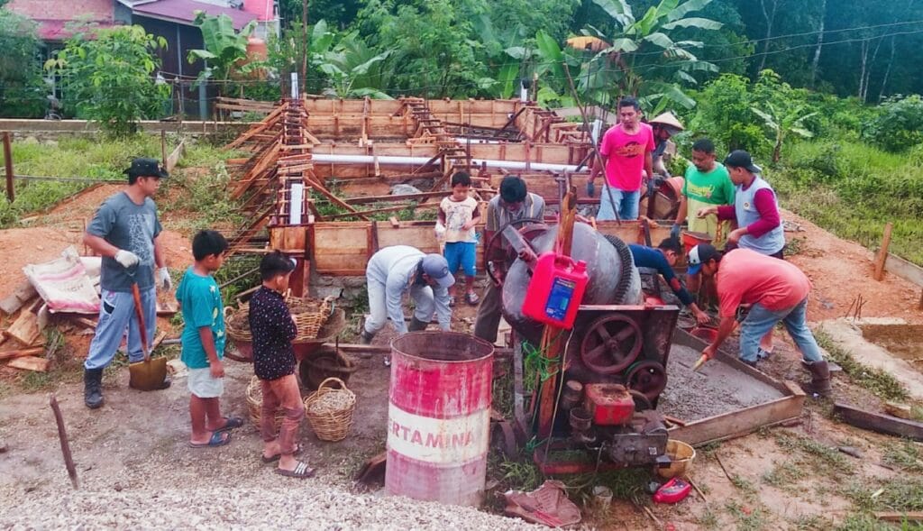 Bakti sosial dan gotong royong LDII Sungai terik dalam pengecoran pondasi TPA Darrul Muttaqin. Foto: Lines
